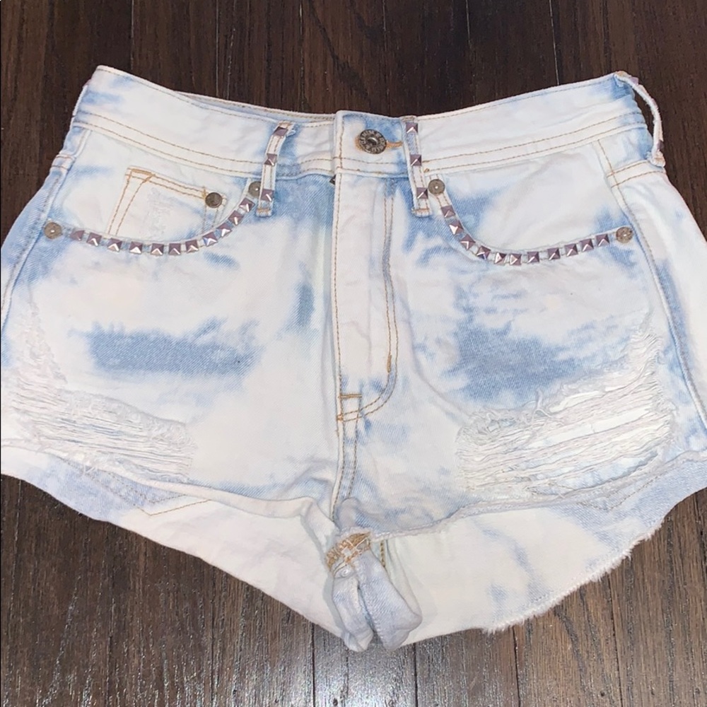 Distressed tie dye denim shorts